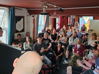 A group gathered in a pub to hear a talk by Dr. Linda Birkin.