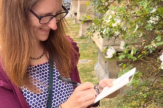 Woman sketching a picture of some plants