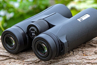 Nottinghamshire Wildlife Trust branded binoculars on log