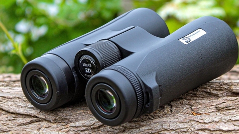 Nottinghamshire Wildlife Trust branded binoculars on log