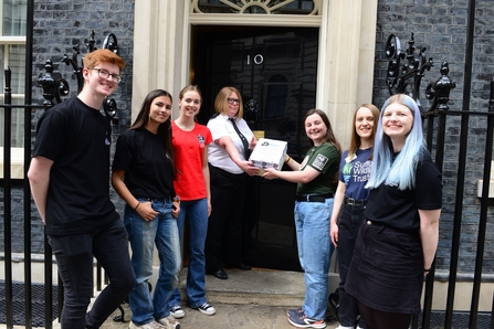 Handing the letter and petition into Number 10 downing street