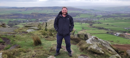 Graham Osborn stood on a rocky outcrop