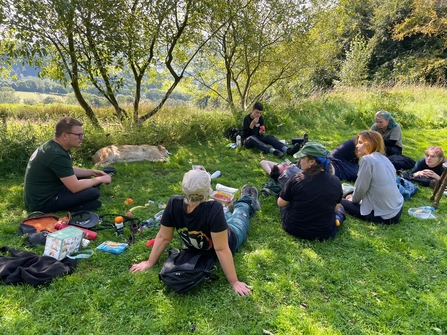 People sitting on grass and eating