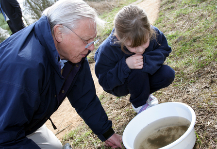 Sir David Attenborough with young girl spotting underwater wildlife