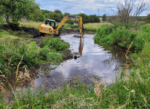 Machinery dredging a river